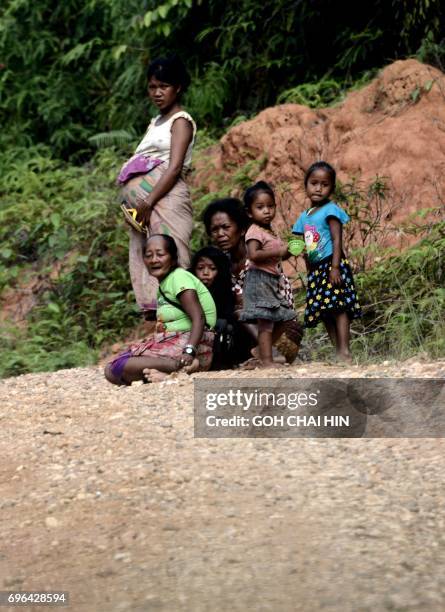 This photo taken on May 19, 2017 shows women from the Indonesian "Orang Rimba" tribe -- whose name translates as "jungle people", who consider being...