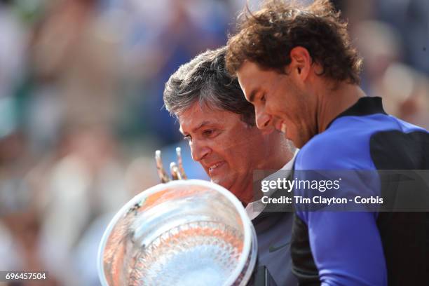 French Open Tennis Tournament - Day Fifteen. Uncle Toni Nadal presents the trophy in honor of Rafael Nadal of Spain's tenth Round Garros Men's...