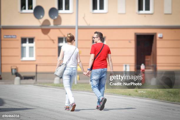 Young couple is seen walking hand in hand near the opera on 15 June, 2017.