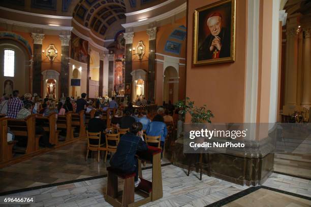 People are seen attending a mass on Corpus Christi day at the Vincent de Paul basilica on 15 June, 2017. Corpus Christi is a national holiday in...
