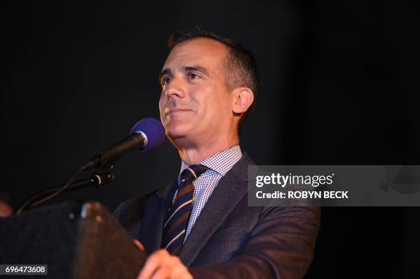 Los Angeles Mayor Eric Garcetti speaks during a tribute to "Batman" star Adam West that included lighting a Bat-signal in front of City Hall, June 15...