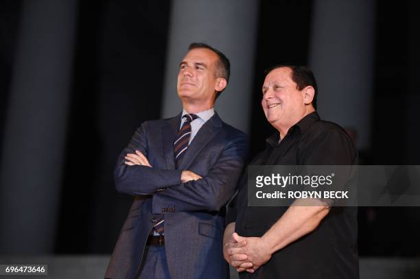 Los Angeles Mayor Eric Garcetti stands with actor Burt Ward , who played Robin, during a tribute to "Batman" star Adam West that included lighting a...