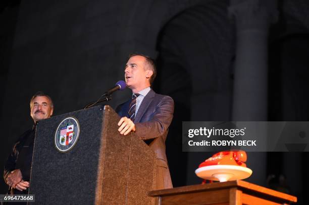 Los Angeles Mayor Eric Garcetti speaks next to a Bat-Phone as Los Angeles Police Chief Charlie Beck listens during a tribute to "Batman" star Adam...