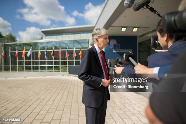 Philip Hammond, U.K. Chancellor of the exchequer, speaks to journalists as he arrives for an Ecofin meeting of European Union finance ministers in...