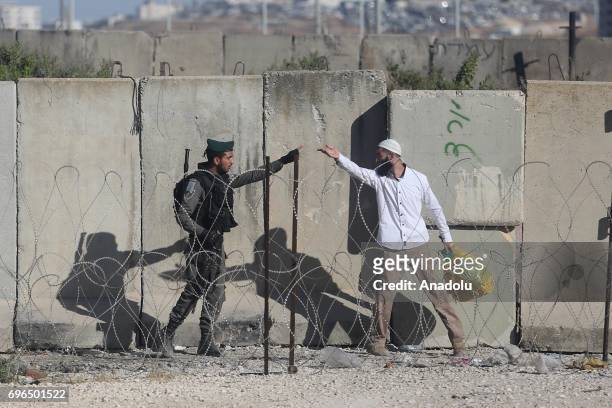 Israeli forces intervene the Palestinian worshippers, as they try to move for passing through the Qalandiya checkpoint from Ramallah into Jerusalem...
