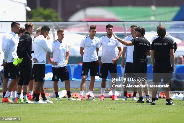 Joachim Loew , head coach of the German national team talks to his players during a training session at Park Arena training ground on June 16, 2017...