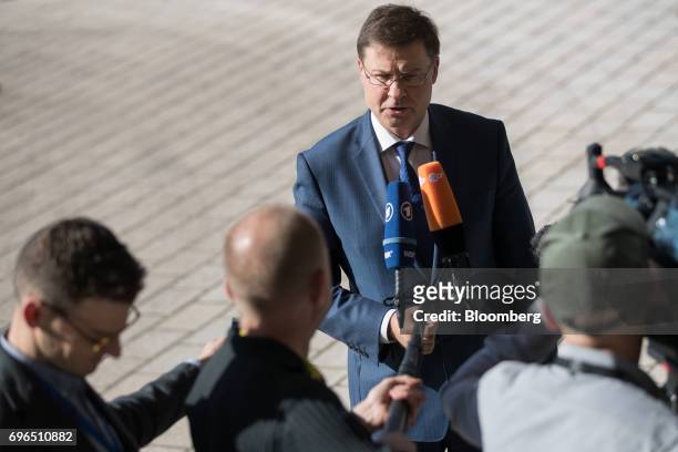 Valdis Dombrovskis, vice president of the European Commission, speaks to journalists as he arrives for an Ecofin meeting of European Union finance...