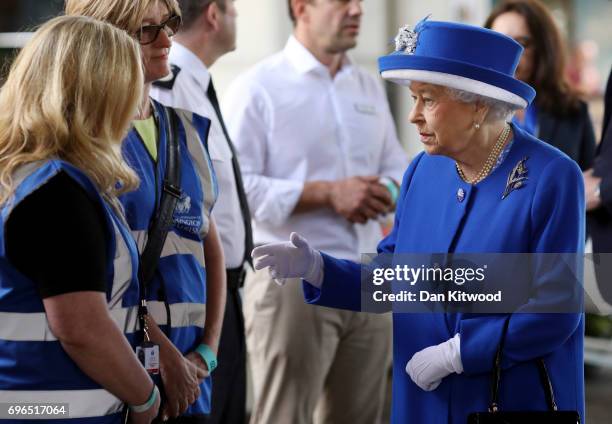 Queen Elizabeth II visits the scene of the Grenfell Tower fire on June 16, 2017 in London, England. 17 people have been confirmed dead and dozens...