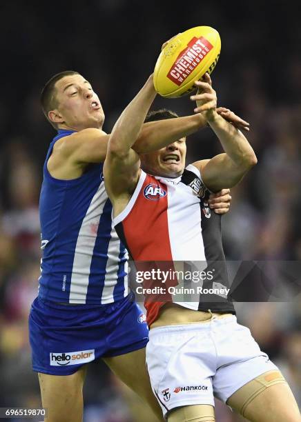Leigh Montagna of the Saints marks infront of Nathan Hrovat of the Kangaroos during the round 13 AFL match between the North Melbourne Kangaroos and...