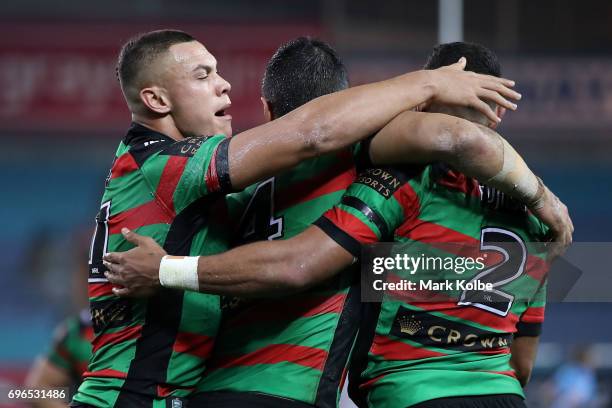 Tyrell Fuimaono and Bryson Goodwin of the Rabbitohs celebrate with Alex Johnston of the Rabbitohs after scoring a try during the round 15 NRL match...