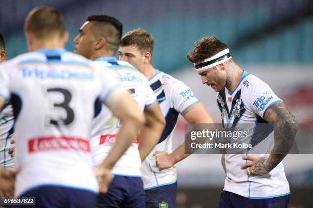 Chris McQueen of the Titans and his team mates look dejected after a Rabbitohs try during the round 15 NRL match between the South Sydney Rabbitohs...