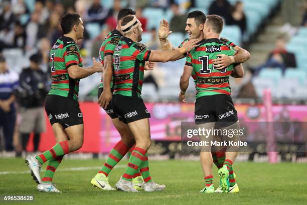 Bryson Goodwin of the Rabbitohs celebrates with his team mates after scoring a try during the round 15 NRL match between the South Sydney Rabbitohs...