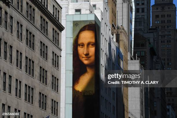 Picture of the Mona Lisa painting hangs on the side of the Louis Vuitton Store on 5th Avenue in New York on June 15, 2017 to promote the Women's Da...