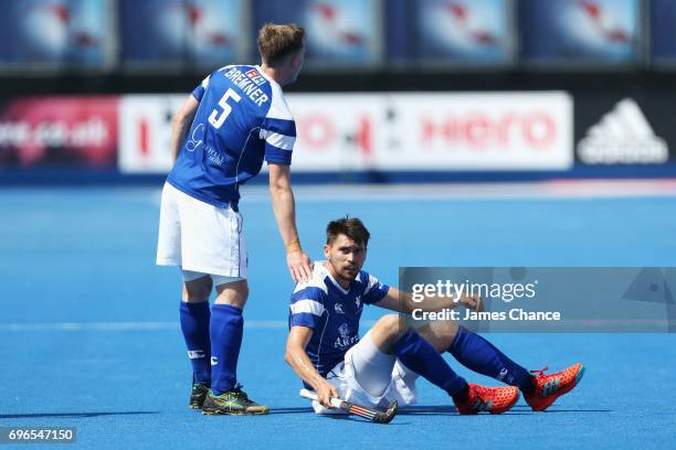 Callum Duke of Scotland reacts as Michael Bremner of Scotland offers him a hand during the Pool B match between India and Scotland on day one of Hero...