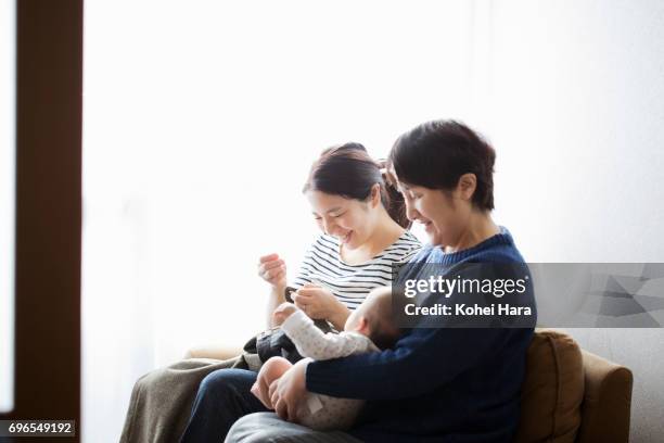 family relaxed at home - navy blue living room stock pictures, royalty-free photos & images