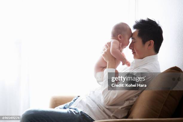 father and baby relaxed at home - no clothes girls stock pictures, royalty-free photos & images