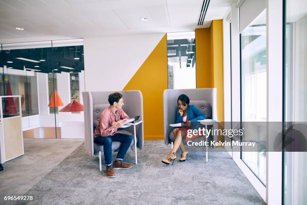 work colleagues having meeting in creative office - yellow carpet stock pictures, royalty-free photos & images