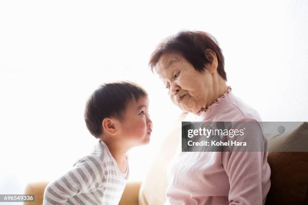 Senior woman and boy playing at home together