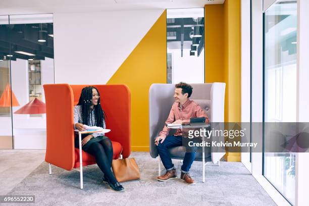 work colleagues having meeting in creative office - sitting chair office relax stock pictures, royalty-free photos & images
