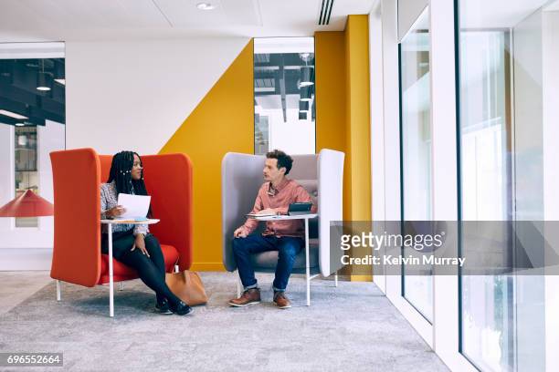 work colleagues having meeting in creative office - chance encounter stock pictures, royalty-free photos & images