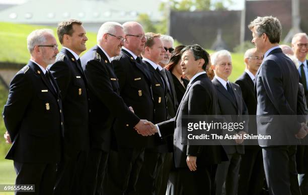 Crown Prince Naruhito of Japan and Crown Prince Frederik of Denmark talk with those engaged in rescue and support operation after the Great East...