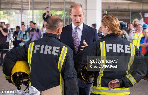 Prince William, Duke of Cambridge meets firefighters and paramedics during a visit to the Westway Sports Centre which is providing temporary shelter...