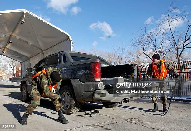 Military personnel inspect vehicles before allowing them to enter the 2002 Winter Olympics athletes village at the University of Utah campus January...