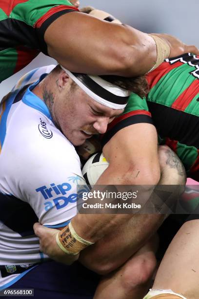 Chris McQueen of the Titans is tackled during the round 15 NRL match between the South Sydney Rabbitohs and the Gold Coast Titans at ANZ Stadium on...