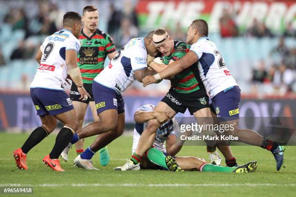 Jason Clark of the Rabbitohs is tackled during the round 15 NRL match between the South Sydney Rabbitohs and the Gold Coast Titans at ANZ Stadium on...