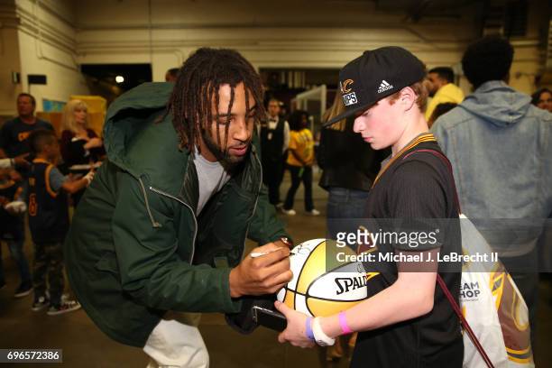 Derrick Williams of the Cleveland Cavaliers signs autographs after the game against the Golden State Warriors in Game Four of the 2017 NBA Finals on...