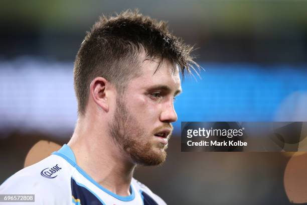 Joe Greenwood of the Titans leaves the field after receiving a head knock during the round 15 NRL match between the South Sydney Rabbitohs and the...