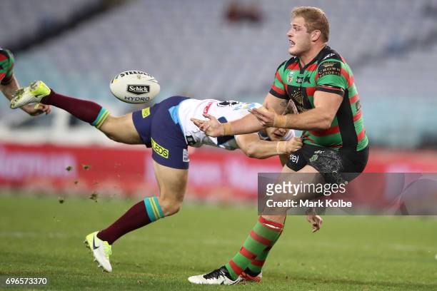 Tom Burgess of the Rabbitohs is tackled during the round 15 NRL match between the South Sydney Rabbitohs and the Gold Coast Titans at ANZ Stadium on...
