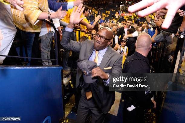Mike Brown of the Golden State Warriors high fives fans as he walks off the court after winning Game Five of the 2017 NBA Finals against the...