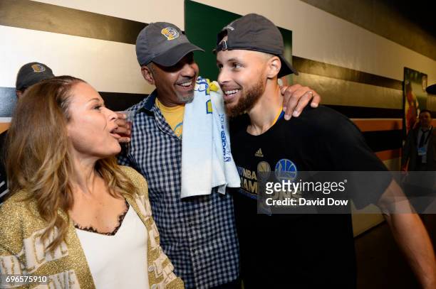 Stephen Curry of the Golden State Warriors celebrates with his father, Dell Curry and his mother, Sonya Curry in the hallway after winning Game Five...