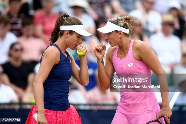 Johanna Konta of Great Britain and Yanina Wickmayer of Belgium talk during their Women's Doubles quarter-final match against Chan Hao-ching of Taiwan...