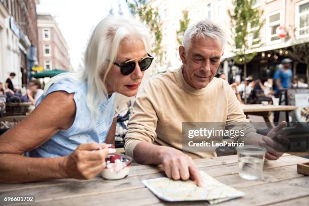 sitting for a break in a cafeteria enjoying amsterdam - weekender stock pictures, royalty-free photos & images
