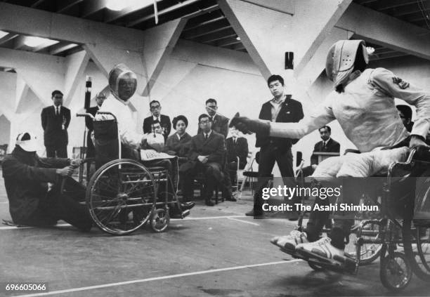 Prince Mikasa, Princess Yuriko and Prince Tomihito of Mikasa watch wheelchair fencing competition during the 1964 Tokyo Paralympic Games on November...