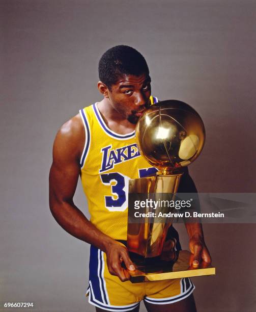 Magic Johnson of the Los Angeles Lakers poses with a trophy circa 1985 at the Great Western Forum in Inglewood, California. NOTE TO USER: User...