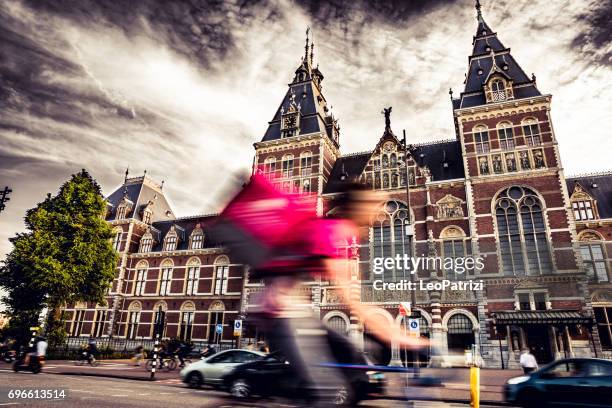 bike deliveries in amsterdam crowded city street - rijksmuseum stock pictures, royalty-free photos & images