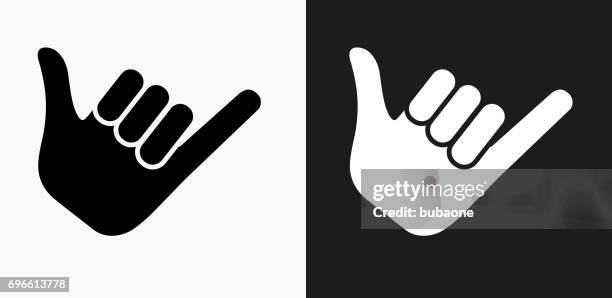 shaka sign icon on black and white vector backgrounds - shaka sign stock illustrations