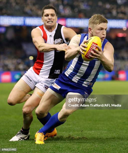 Jack Ziebell of the Kangaroos is tackled by Leigh Montagna of the Saints during the 2017 AFL round 13 match between the North Melbourne Kangaroos and...