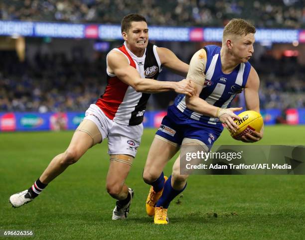 Jack Ziebell of the Kangaroos is tackled by Leigh Montagna of the Saints during the 2017 AFL round 13 match between the North Melbourne Kangaroos and...