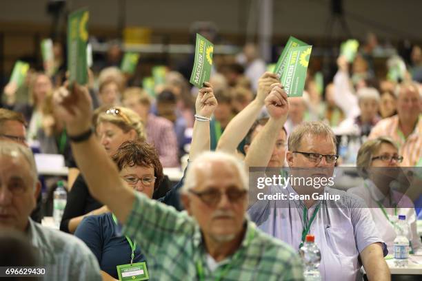 Delegates of the German Greens Party vote on a preliminary measure on the first day of the Greens Party federal congress on June 16, 2017 in Berlin,...