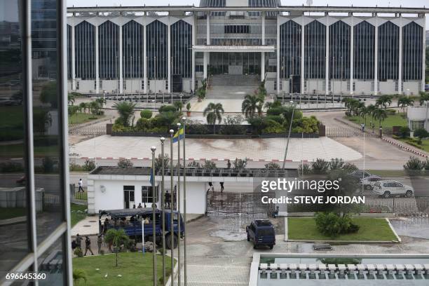 Gabonese security forces stand guard at the premises of the National Radio and Television centre in Libreville, on June 16 after unknown assailants...