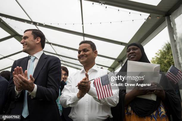 Immigrants applaud after taking the oath of citizenship to the United States during a naturalization ceremony at Franklin D. Roosevelt Four Freedoms...