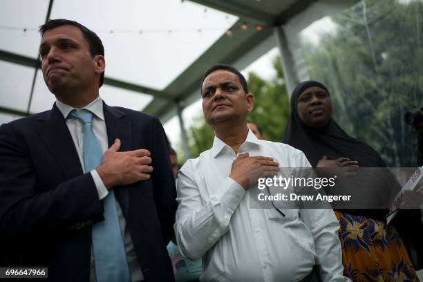 Immigrants recite the Pledge of Allegiance during a naturalization ceremony at Franklin D. Roosevelt Four Freedoms Park on Roosevelt Island, June 16,...
