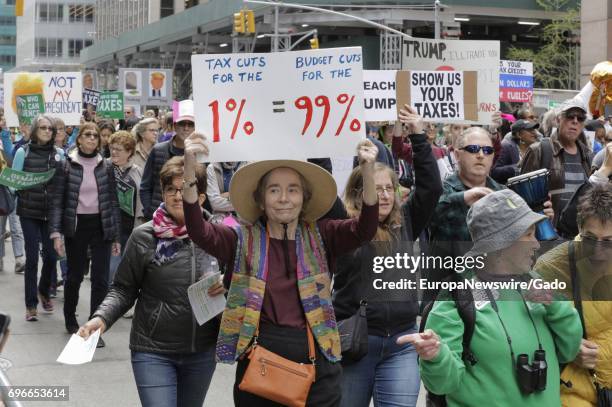 New Yorkers and visiting demonstrators protest during a march on Tax Day demanding that President Donald Trump release his tax returns, at Sixth...