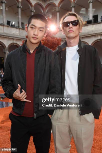 Qu Chuxiao and Jamie Campbell Bower attend the Ermenegildo Zegna show during Milan Men's Fashion Week Spring/Summer 2018 on June 16, 2017 in Milan,...