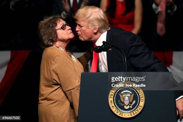President Donald Trump kisses Cuban dissident Cary Roque as he speaks about policy changes he is making toward Cuba at the Manuel Artime Theater in...
