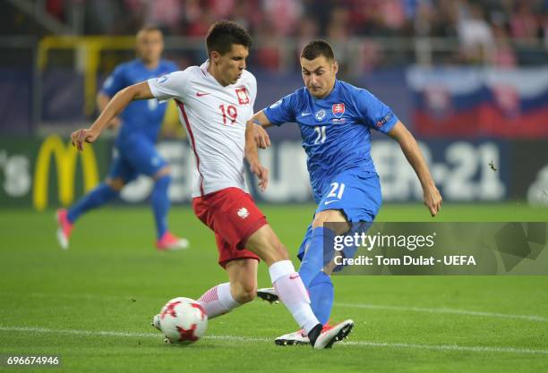 Matus Bero of Slovakia shoots past Bartosz Kapustka of Poland during the UEFA European Under-21 Championship match between Poland and Slovakia at...